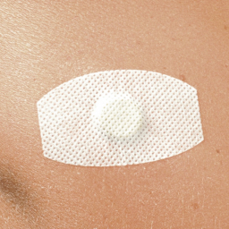 Aimants Thérapeutiques Medimag® Titanium Ø 11mm AURIS collé sur peau avec adhésif blanc
